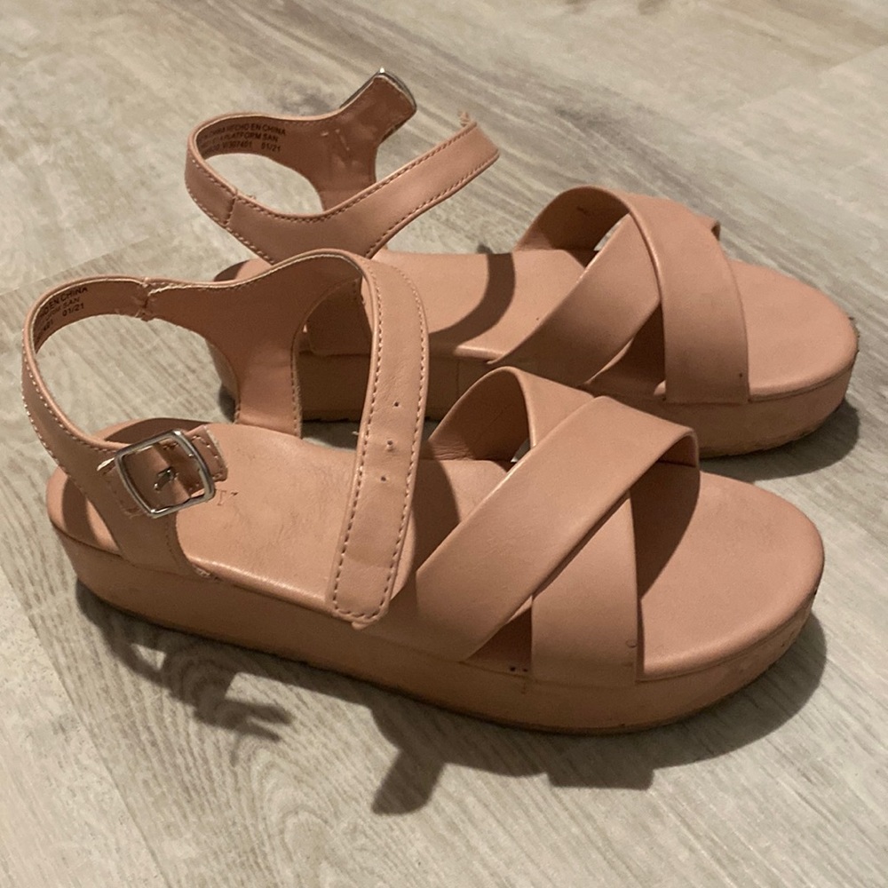 Girls pink nude platform sandals with ankle ties.